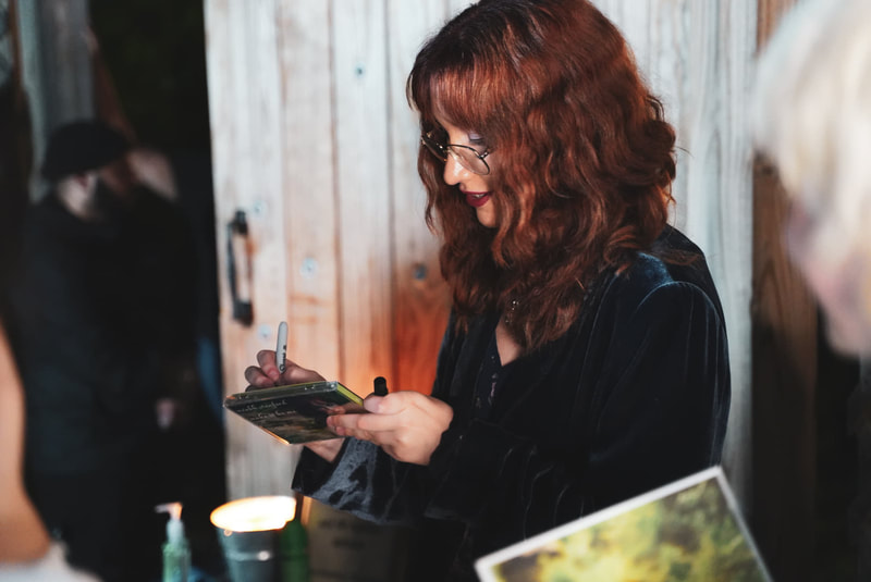 méabh stanford signs autographs at a meet and greet during her ep release party.