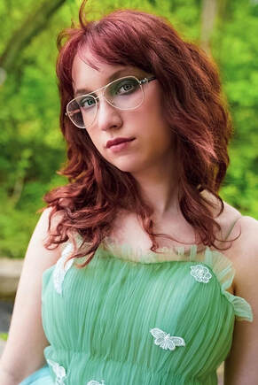 méabh stanford new female indie pop artist poses in green butterfly dress